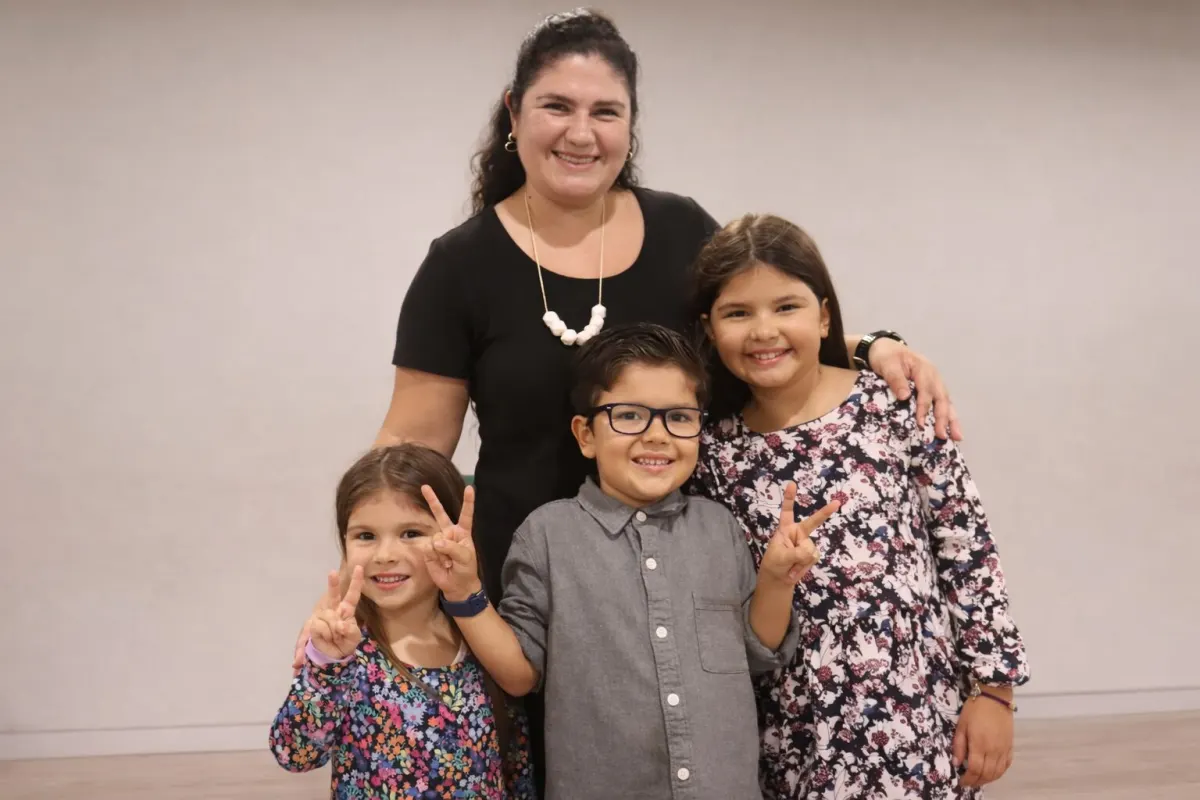 A mother and children from the church family smiling at a fellowship gathering